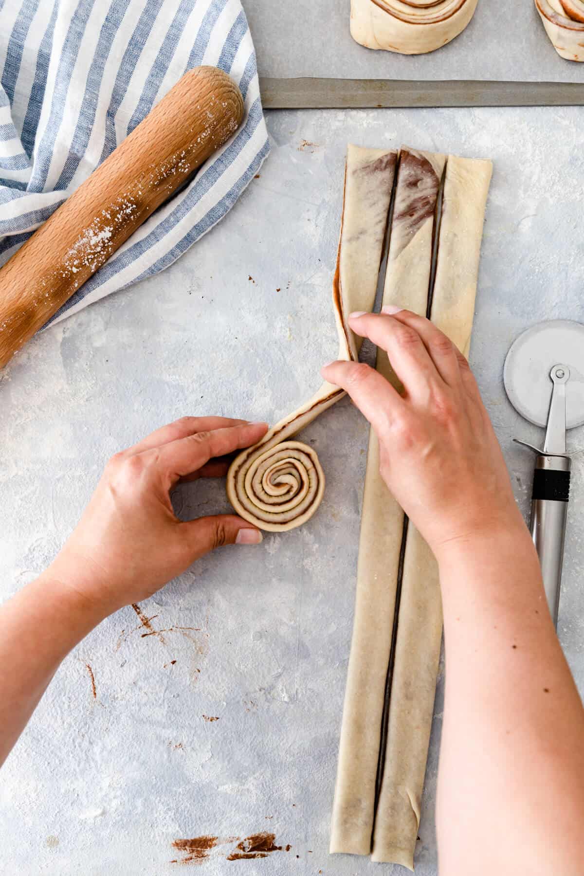 overhead shot showing dough being rolled into swirl