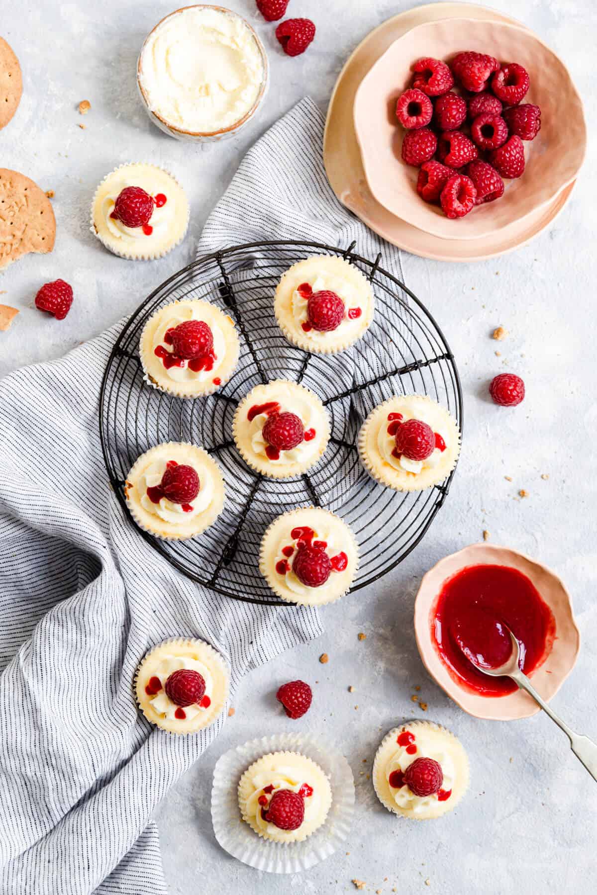 overhead shot of individual cheesecakes with raspberry drizzle