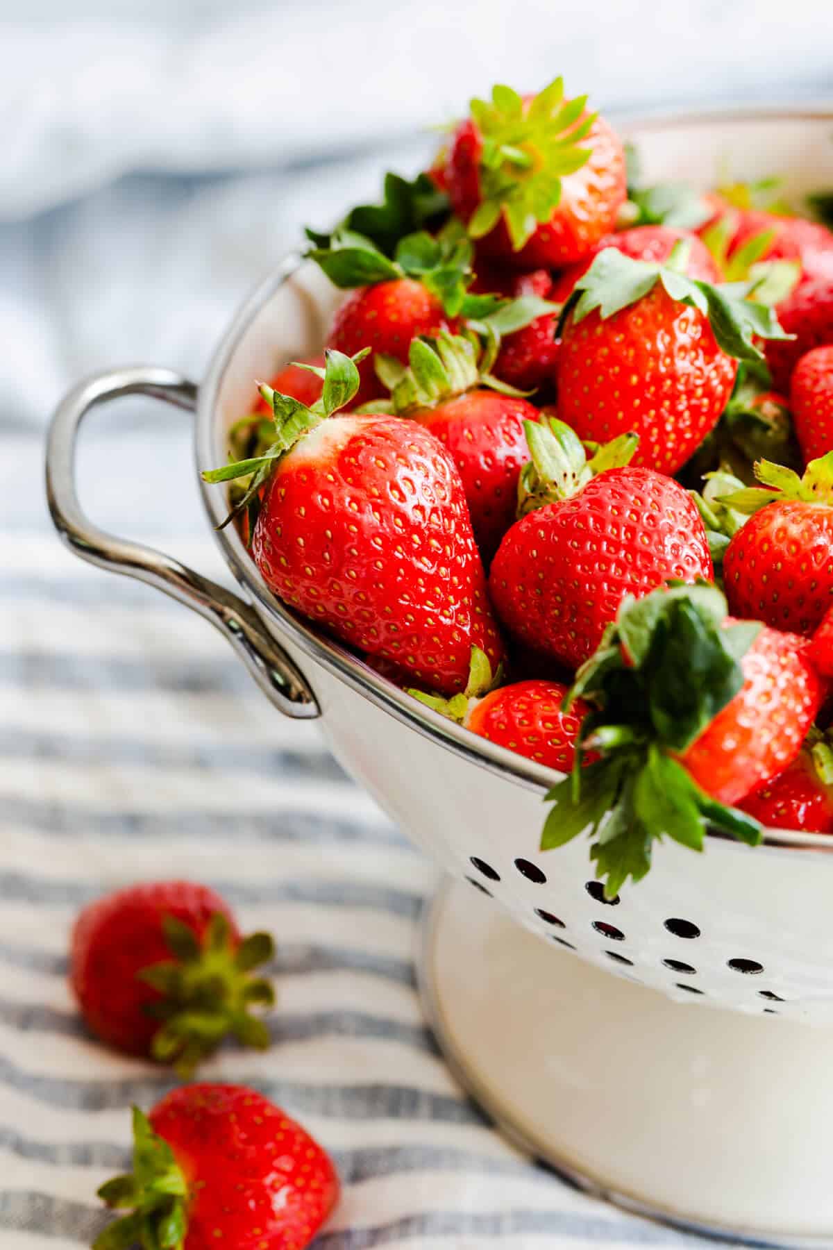 side close up at fresh strawberries in colander
