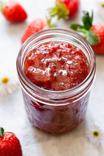top view close up of open jar with strawberry jam