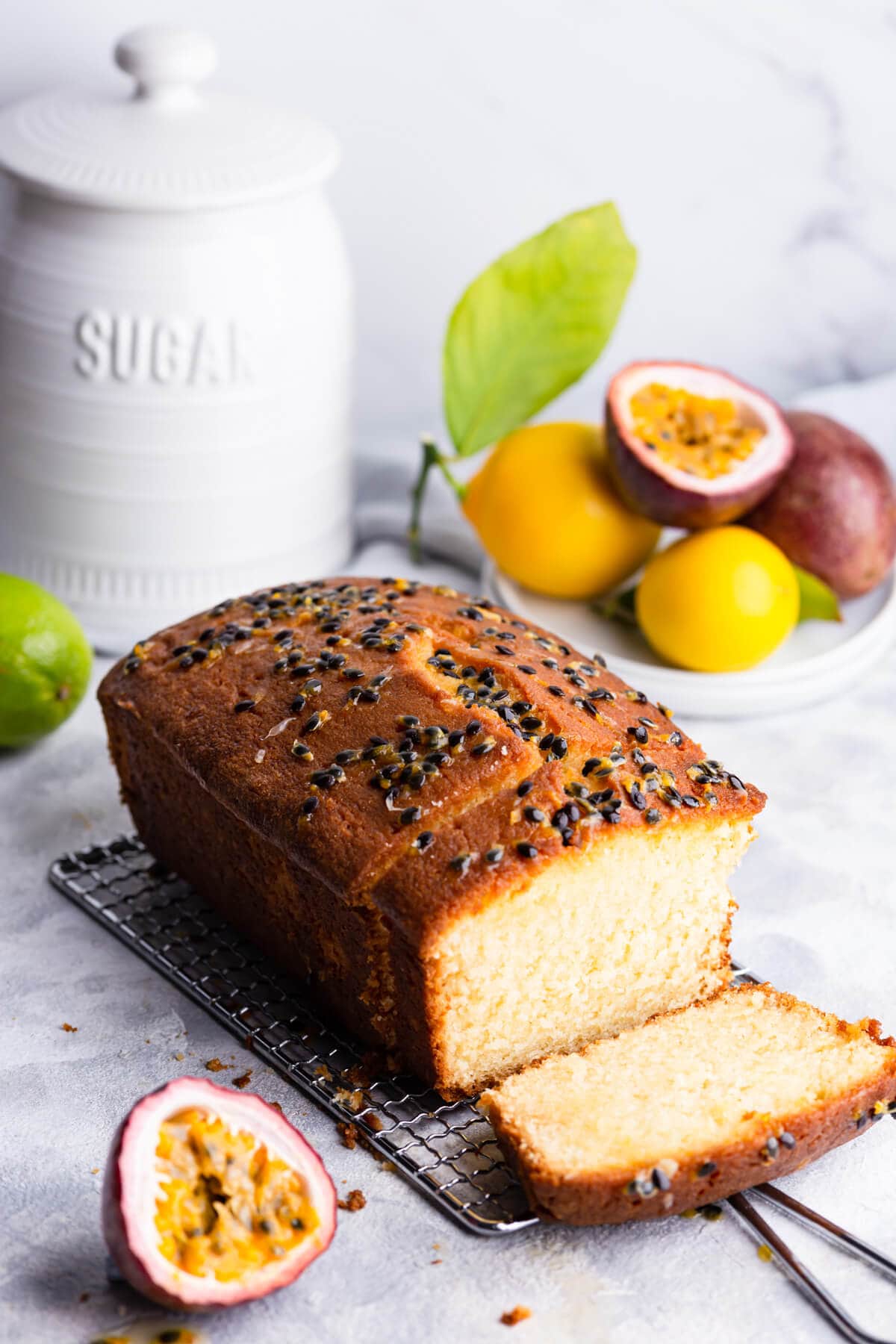 45 degree angle view of a loaf cake topped with passion fruit seeds