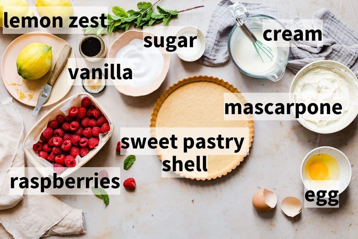 ingredients for raspberry mascarpone tart in bowls and with text labels.