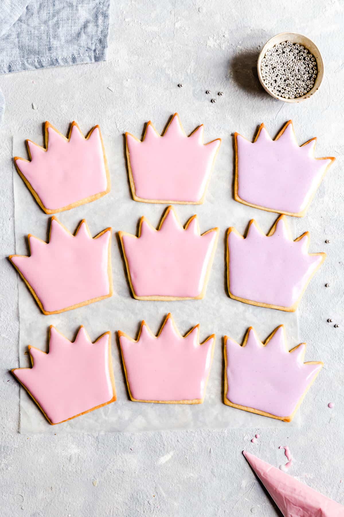 overhead shot of birthday sugar cookies decorated with pink and purple icing