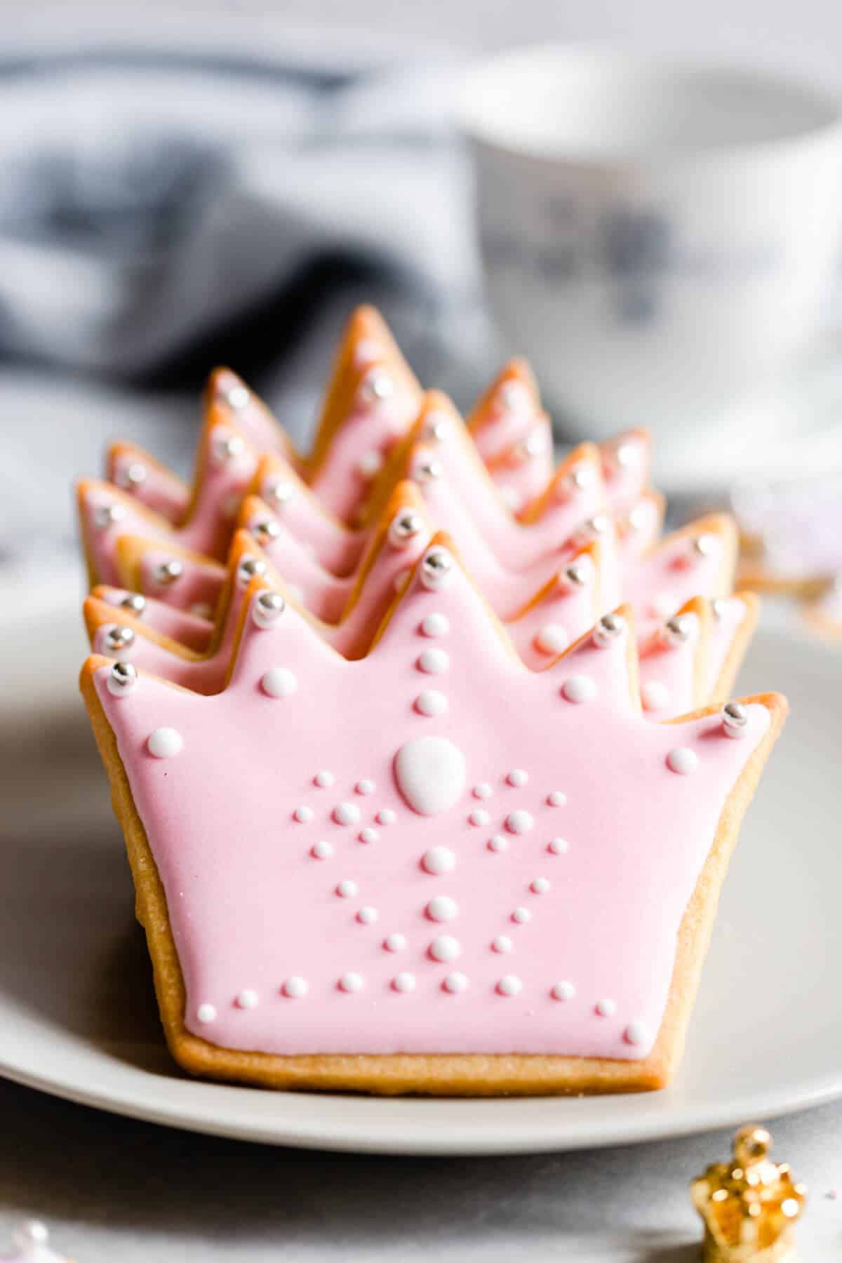super close up of sugar cookies in shape of crown with pink icing