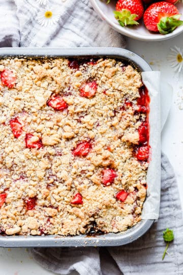 overhead close up at strawberry crumble in a baking tin