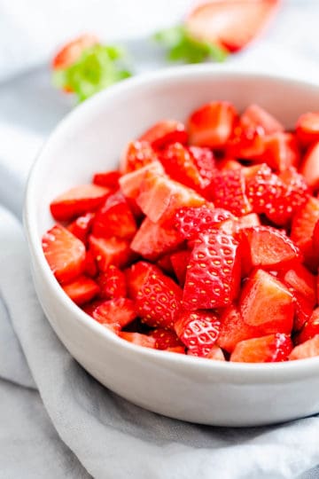 side close up at a bowl with chopped strawberries