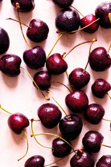 top view of fresh cherries with stems attached