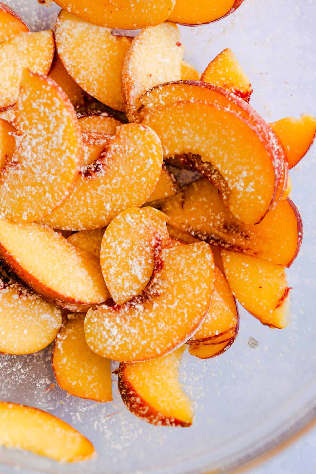 close up of sliced peaches dusted with cornflour