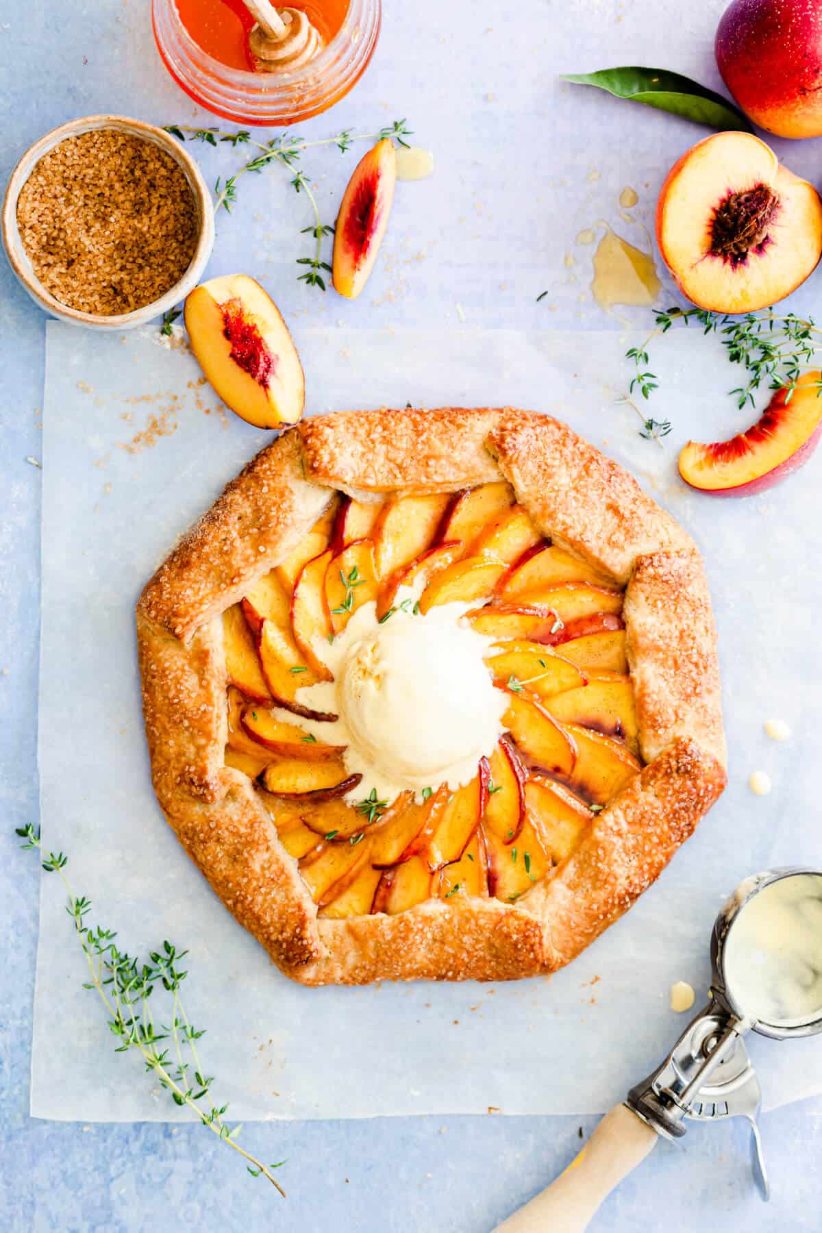 overhead shot of peach galette with a scoop of ice cream on top