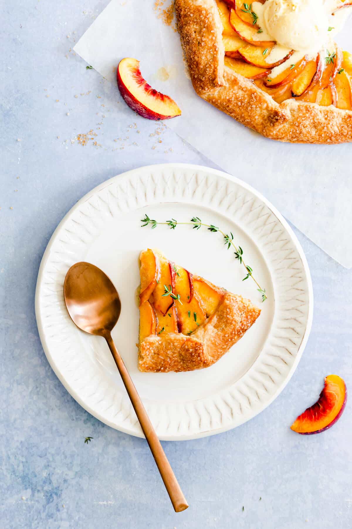 top view of a slice of peach galette on a white plate
