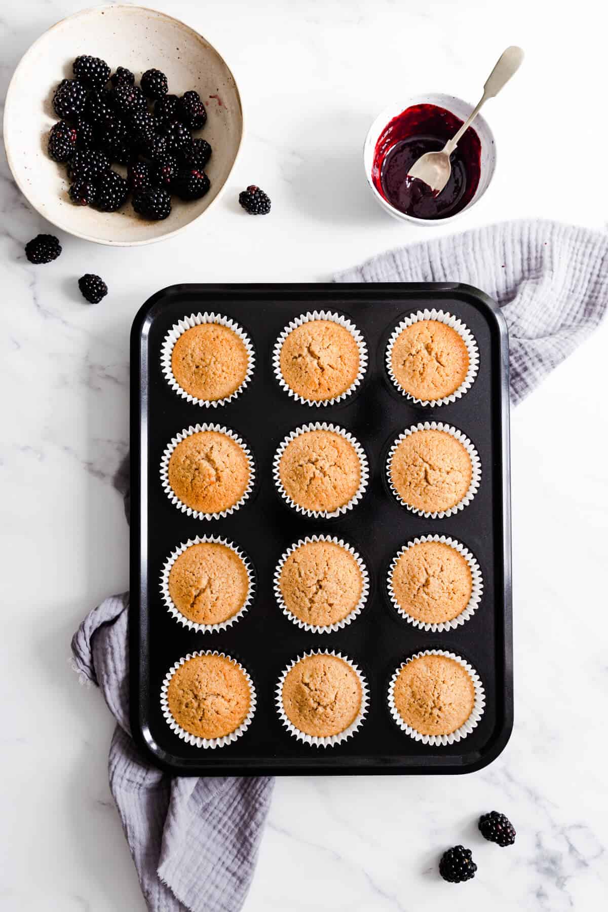 top view of a baking tray with spiced apple cupcakes inside