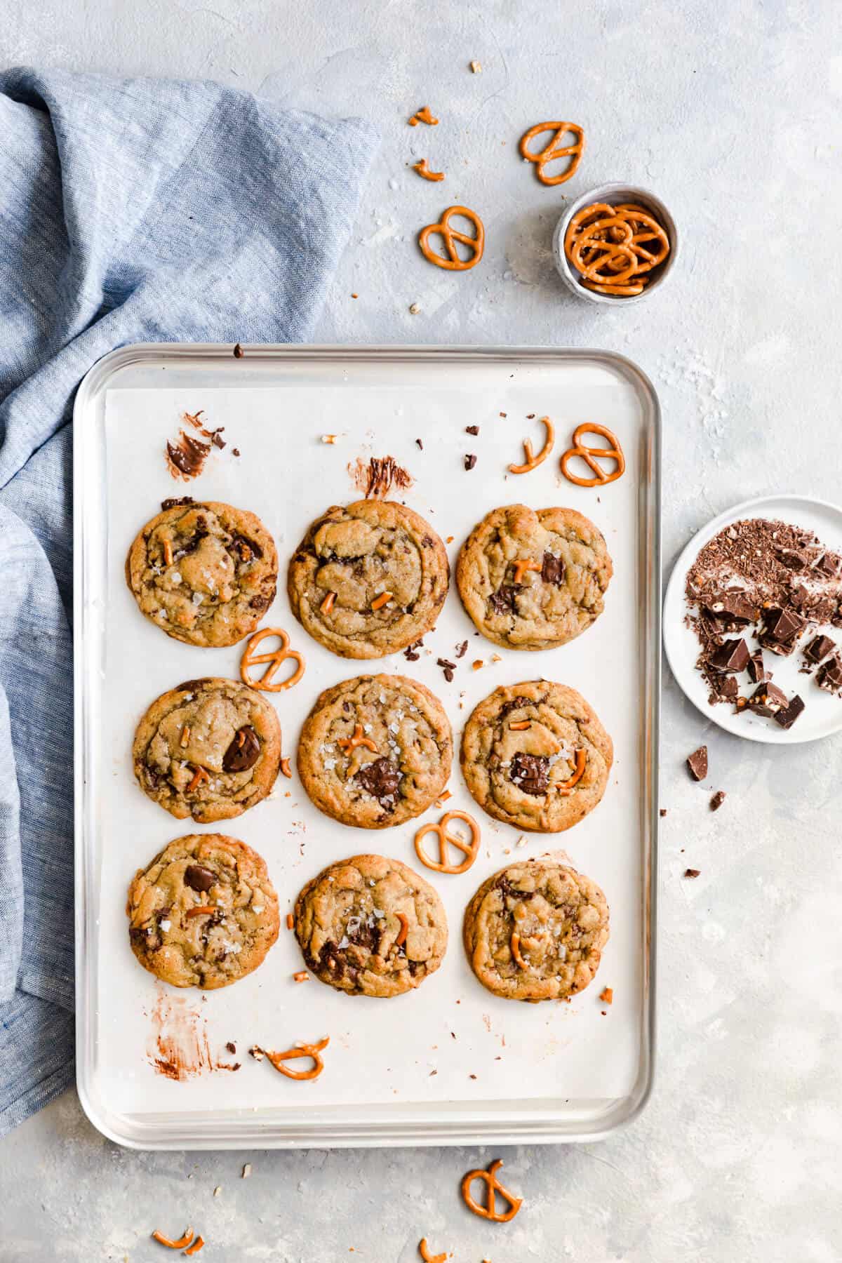 overhead shot at a baking tray with 9 chocolate chip pretzel cookies