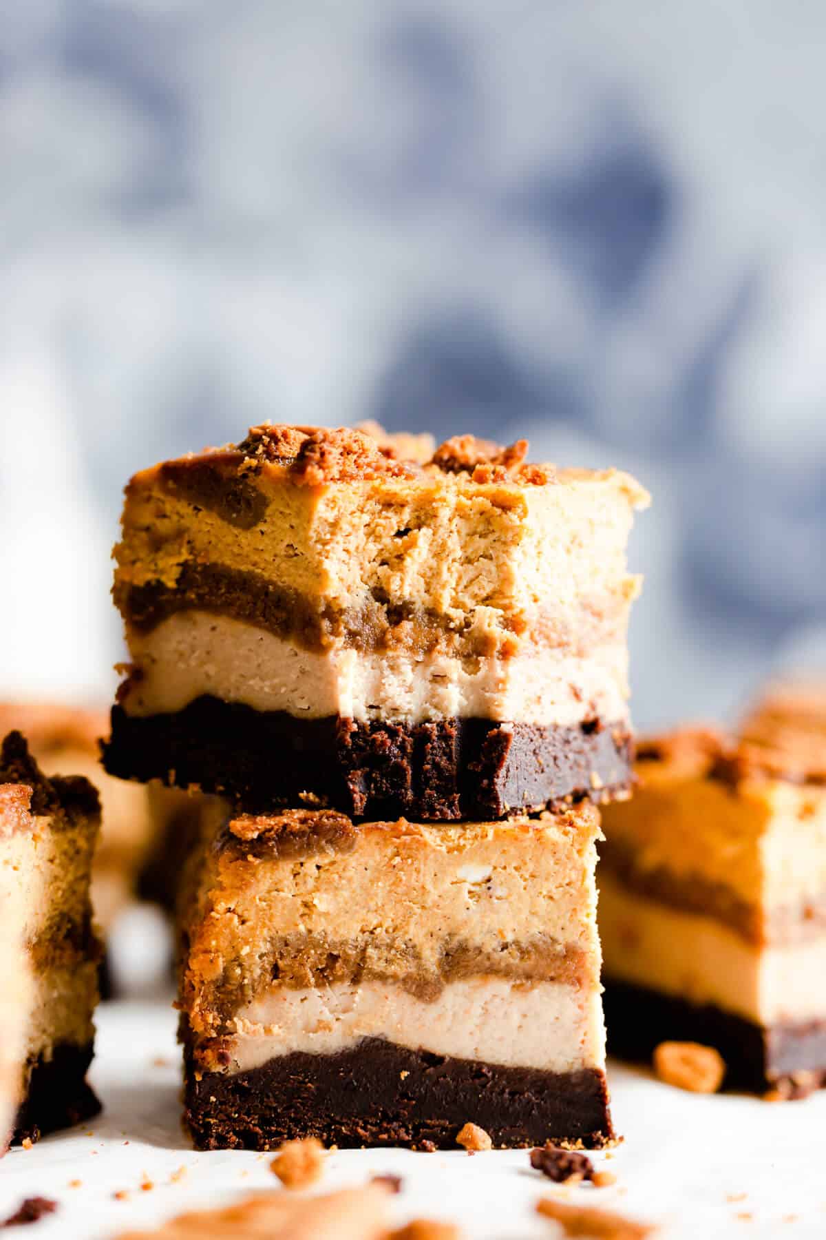 side shot of two pieces of pumpkin biscoff cheesecake stacked together