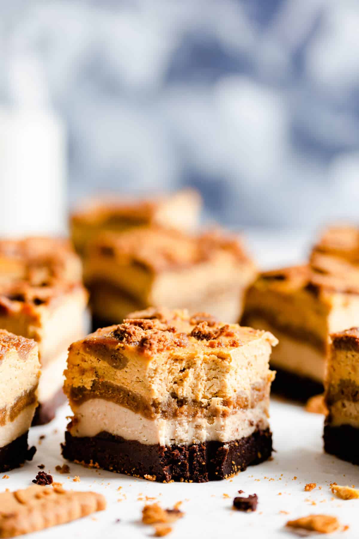 side close up of a pumpkin biscoff cheesecake brownie with bite taken out