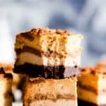side close up at two slices of pumpkin cheesecake bars stacked on top of each other