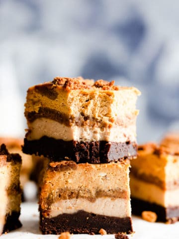 side close up at two slices of pumpkin cheesecake bars stacked on top of each other