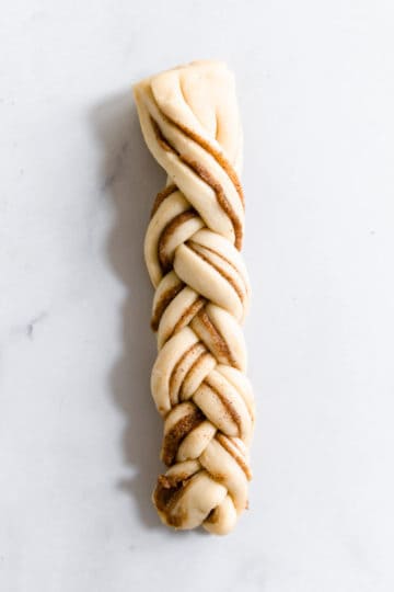 overhead close up of a strip of dough twisted into plait