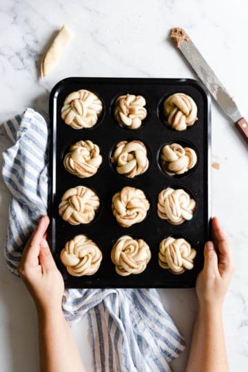 top view of a muffin tray filled with unbaked cinnamon buns