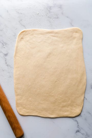 top view of a soft dough rolled into large rectangle
