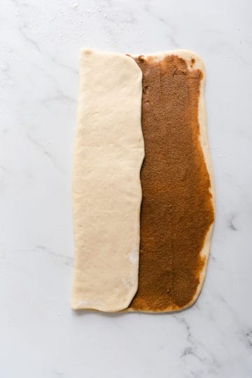 overhead shot of a large rectangle of dough being folded