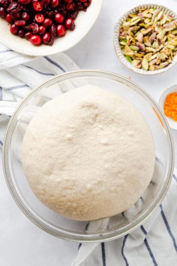 overhead shot of a proven dough in a large bowl