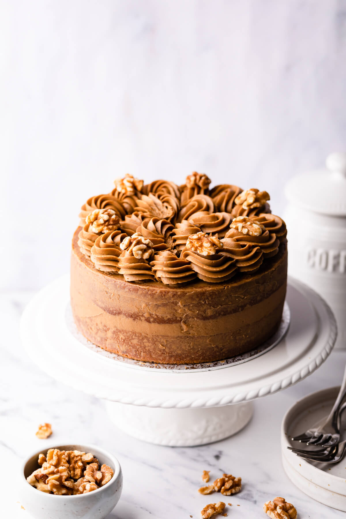 coffee and walnut cake topped with coffee buttercream and walnut halves.