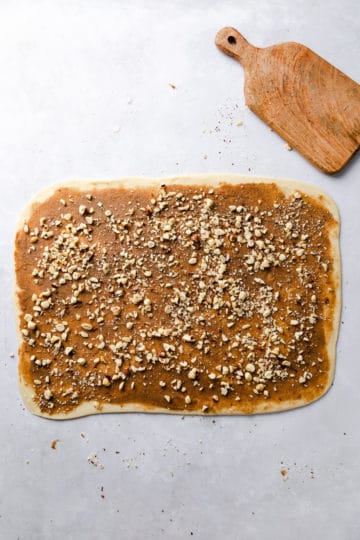 top view of dough rectangle covered in cinnamon butter and chopped hazelnuts