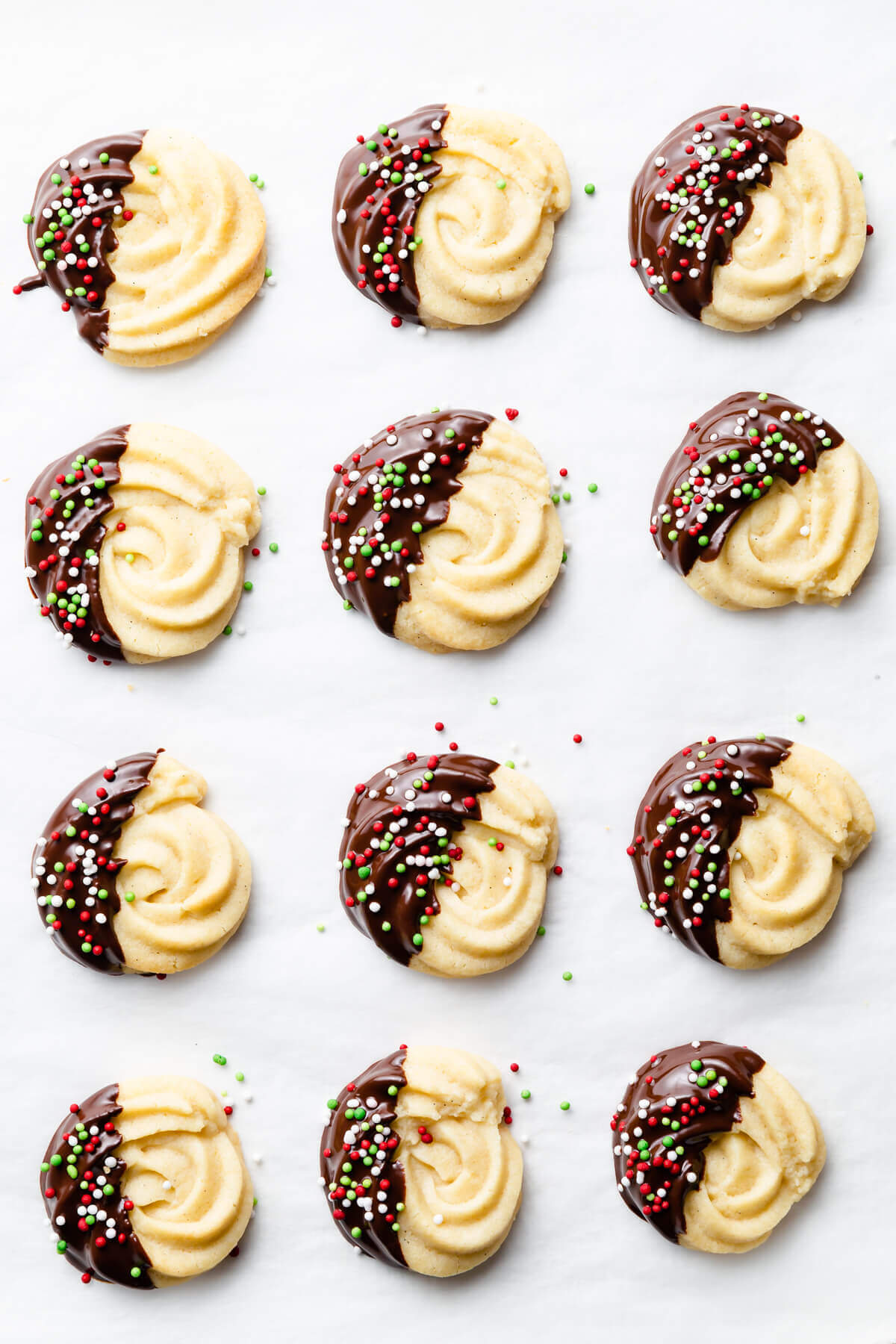 chocolate dipped butter cookies with some sprinkles.