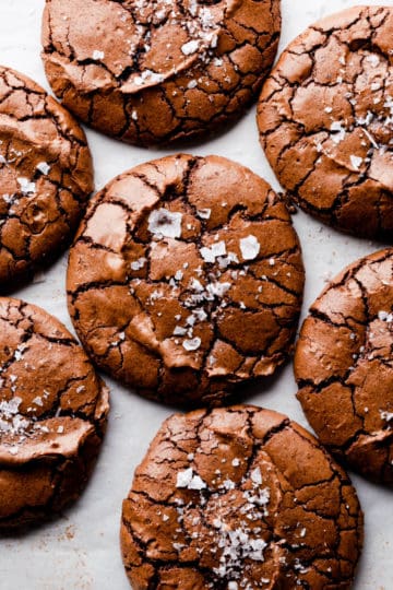 overhead super close up at brownie cookies with crinkled tops and flaked sea salt