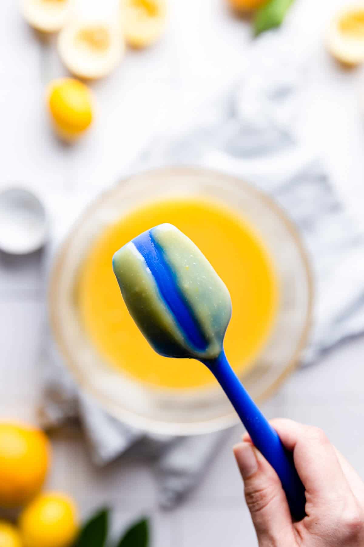 top view of a back of small spatula covered in lemon curd