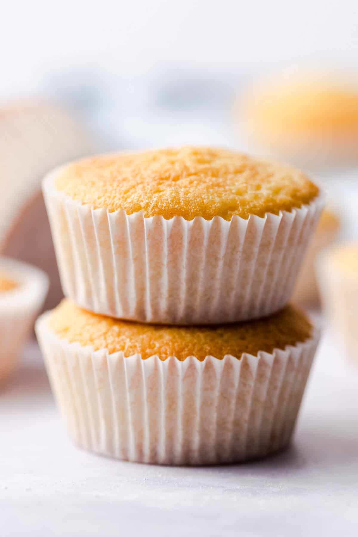 straight ahead super close up of one bowl vanilla cupcakes stacked on top of each other