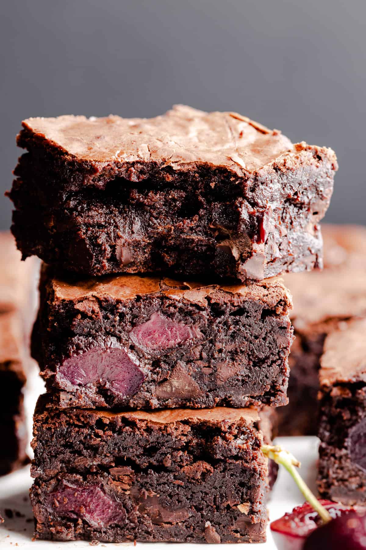 straight ahead view of stack of brownies with bite missing from the top one
