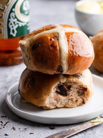 side close up at two chocolate chip hot cross buns on top of each other