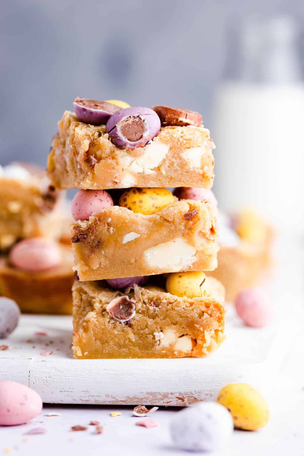 side angle photo of stack of three mini egg blondies