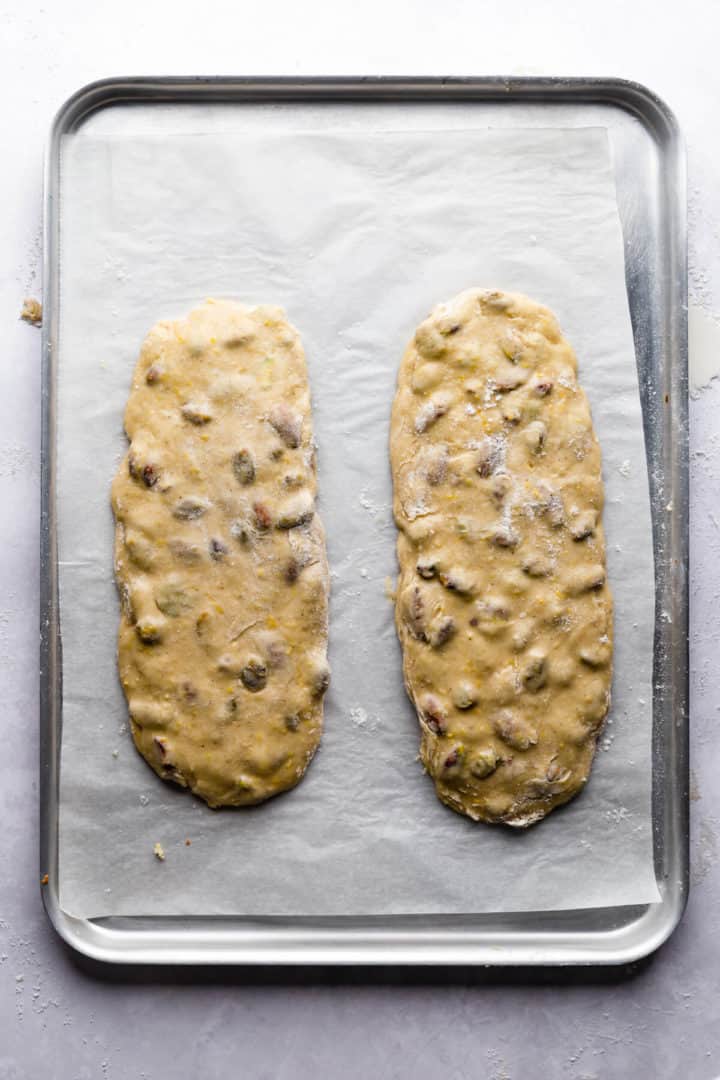 two logs of biscotti dough on a baking tray