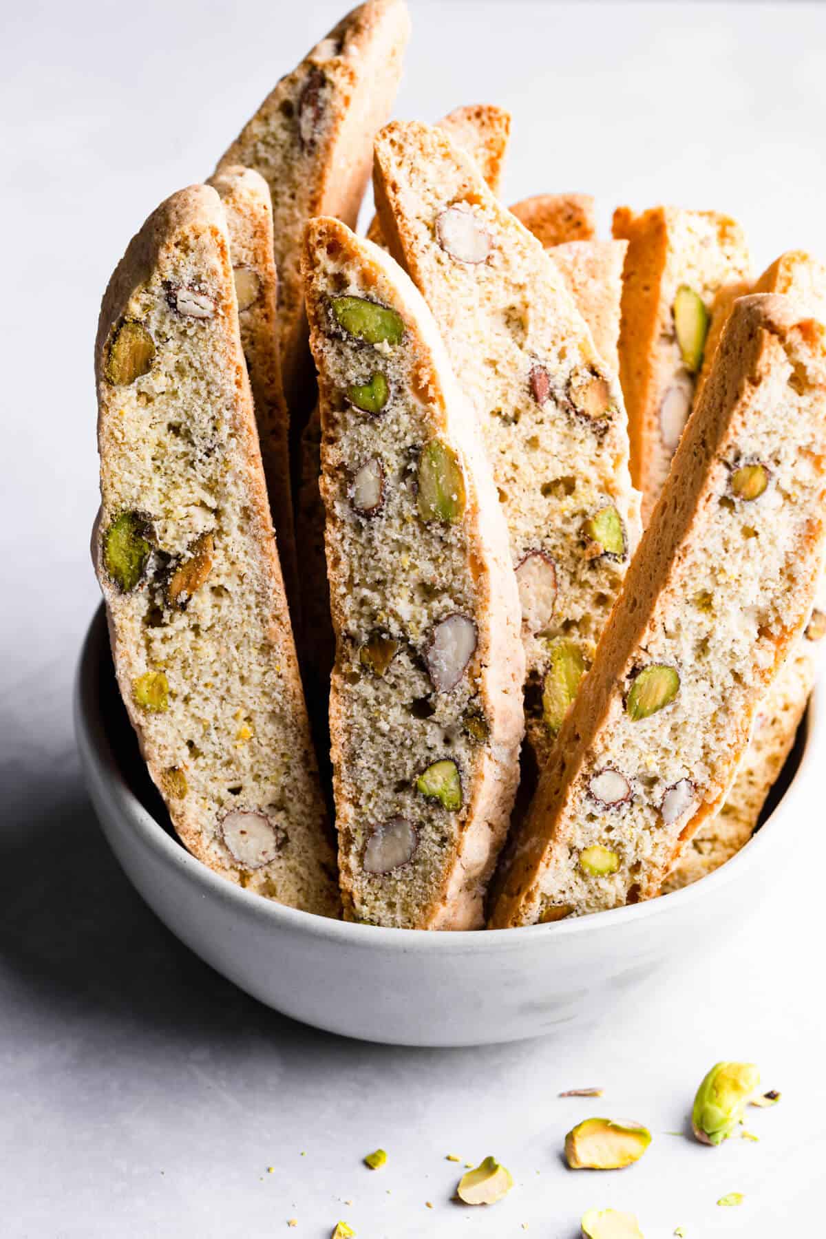 side close up at lemon pistachio biscotti in a bowl