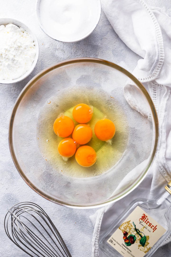 top view of glass bowl with eggs and egg yolks