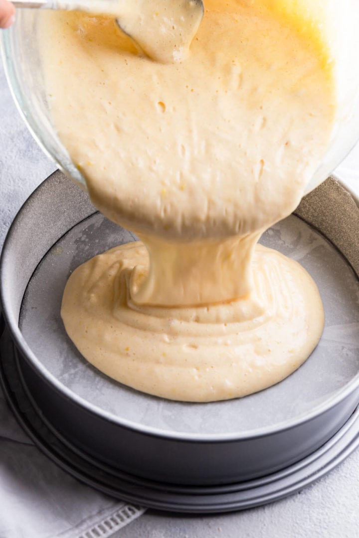 side view of a cake batter being poured into baking tin
