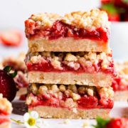 side super close up of a stack of three strawberry crumble bars.