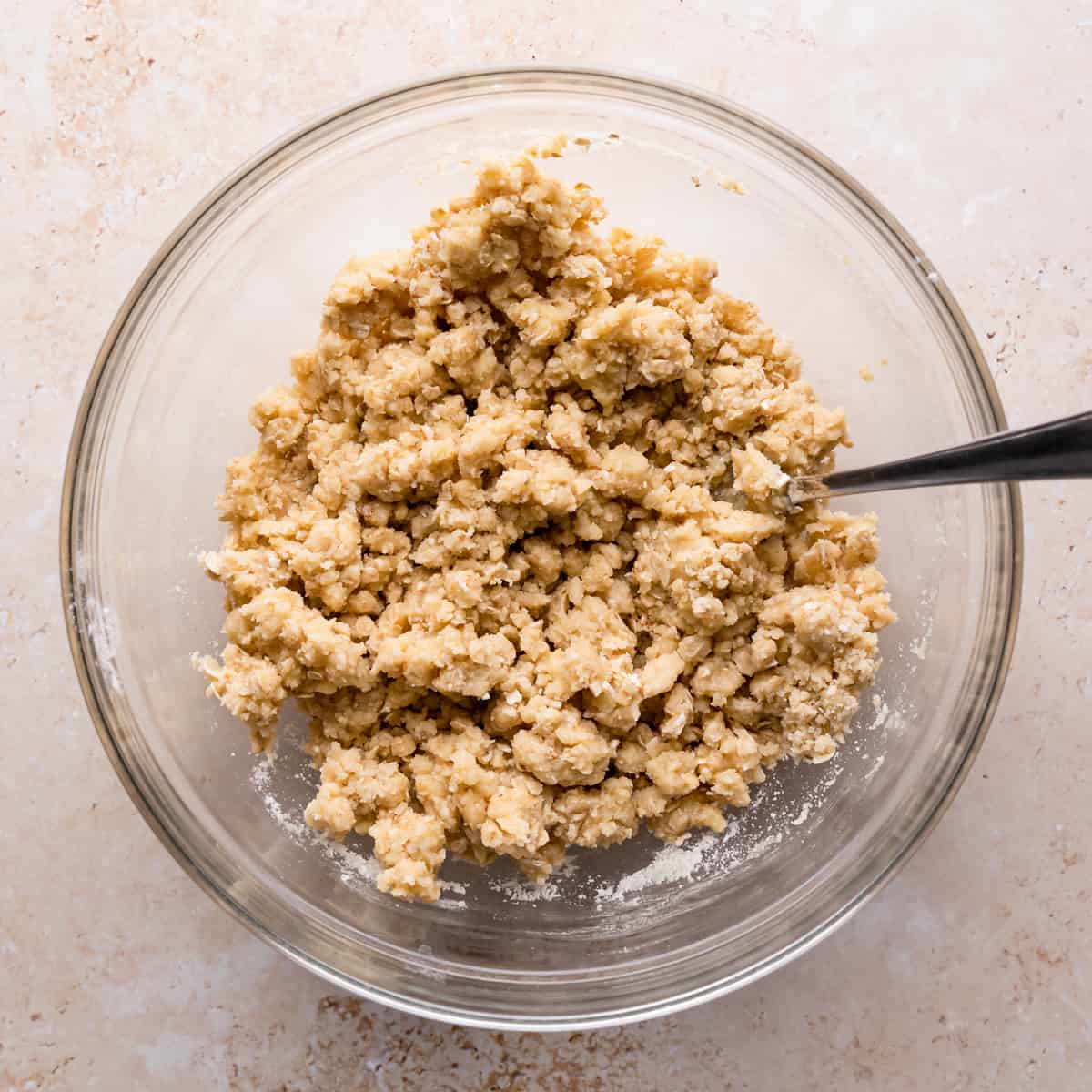 bowl with crumble mixture and fork inside.