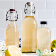 straight ahead close up at glass bottles with elderflower cordial
