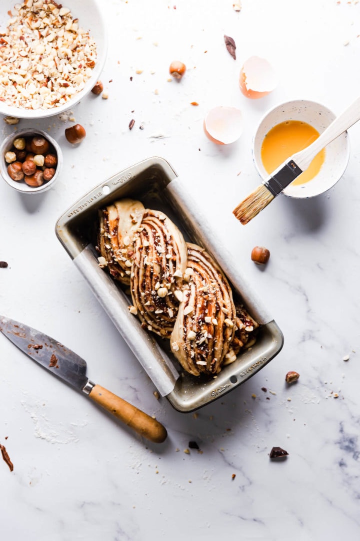 overhead shot of nutella babka in a loaf pan before baking