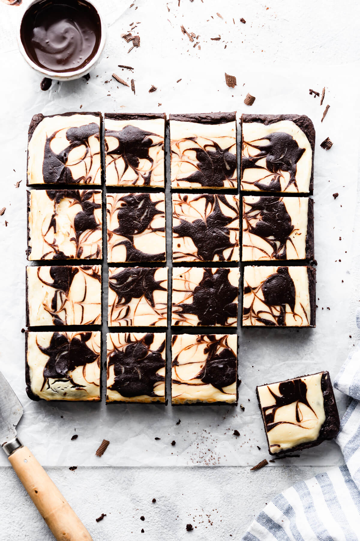 overhead shot of cheesecake brownie cut into squares