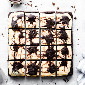 overhead shot of cheesecake topped brownies cut into 12 individual squares