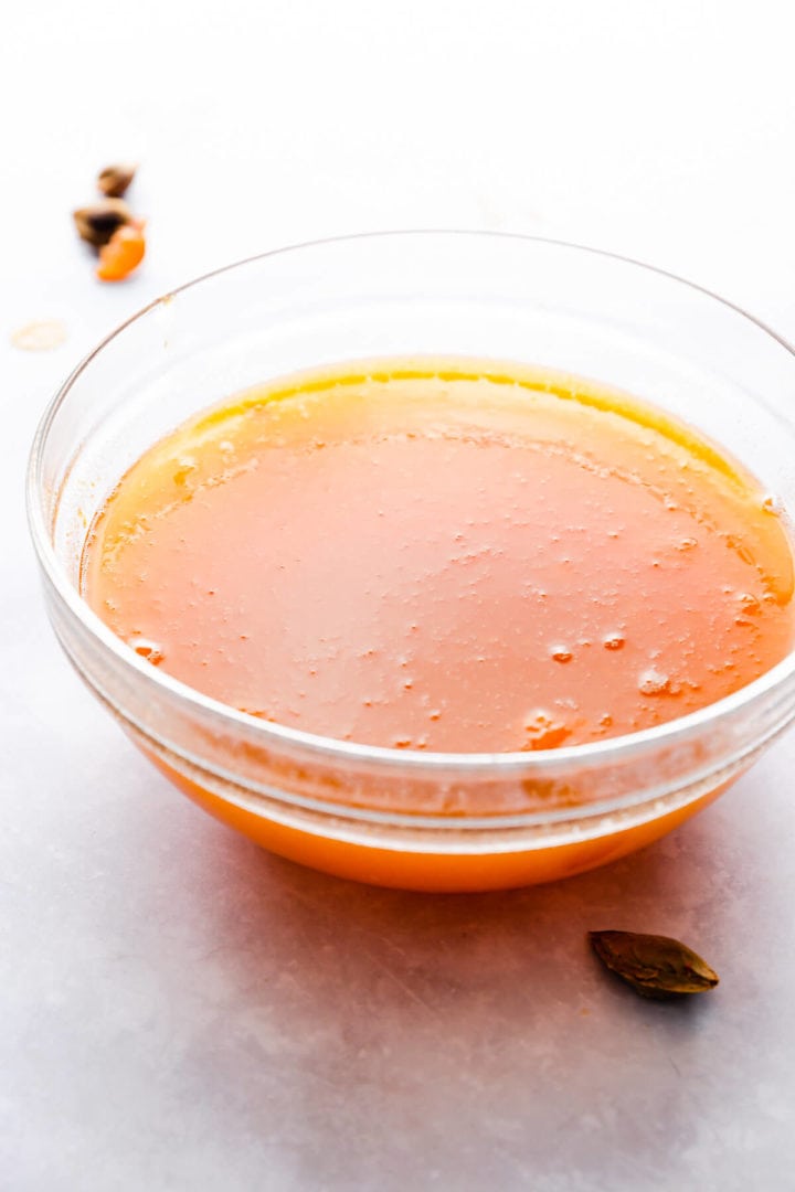 side close up view of a glass bowl filled with homemade apricot nectar