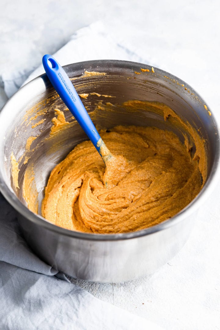 side angle view of a mixing bowl with cake batter for pumpkin loaf cake