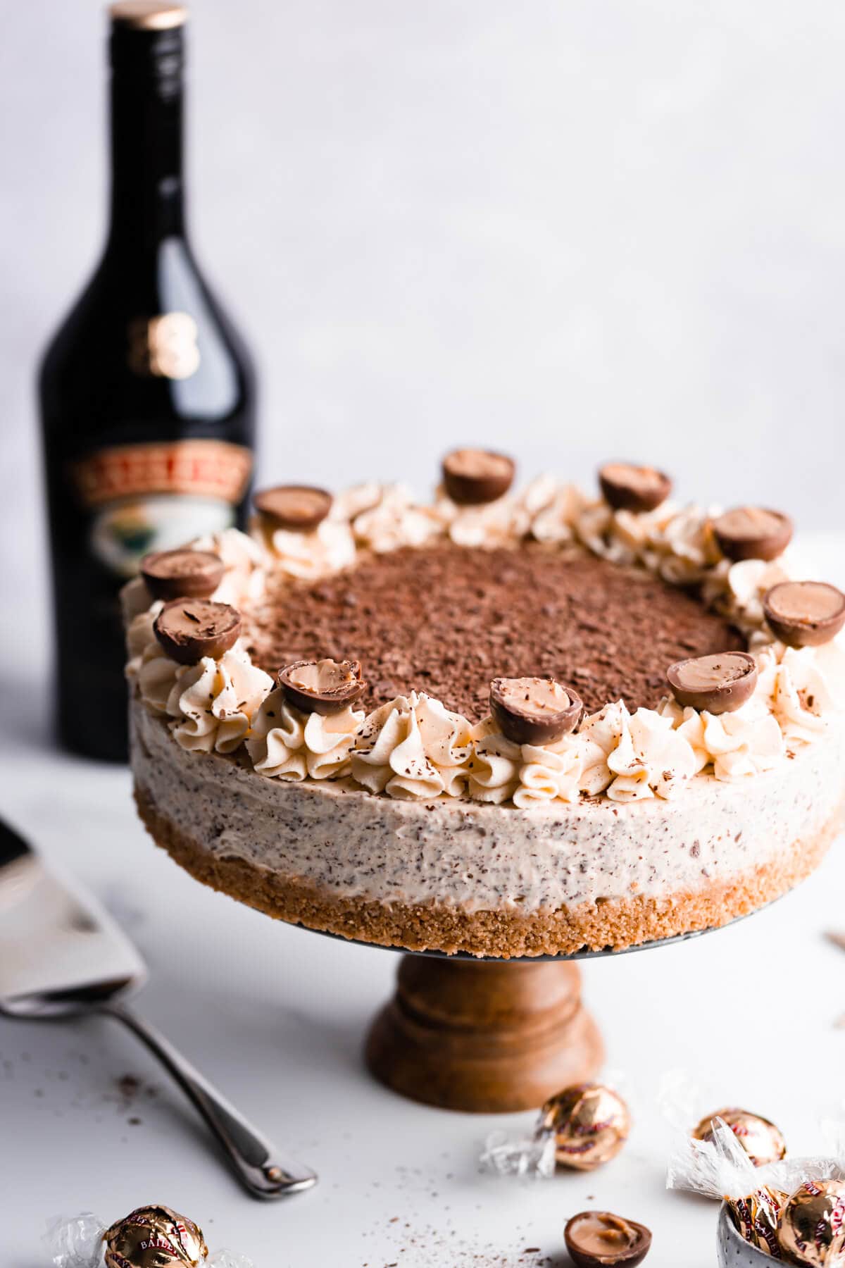 45 degree angle view of the Baileys cheesecake on a cake stand