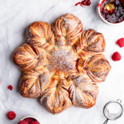 top view close up of a festive raspberry star bread dusted with icing sugar