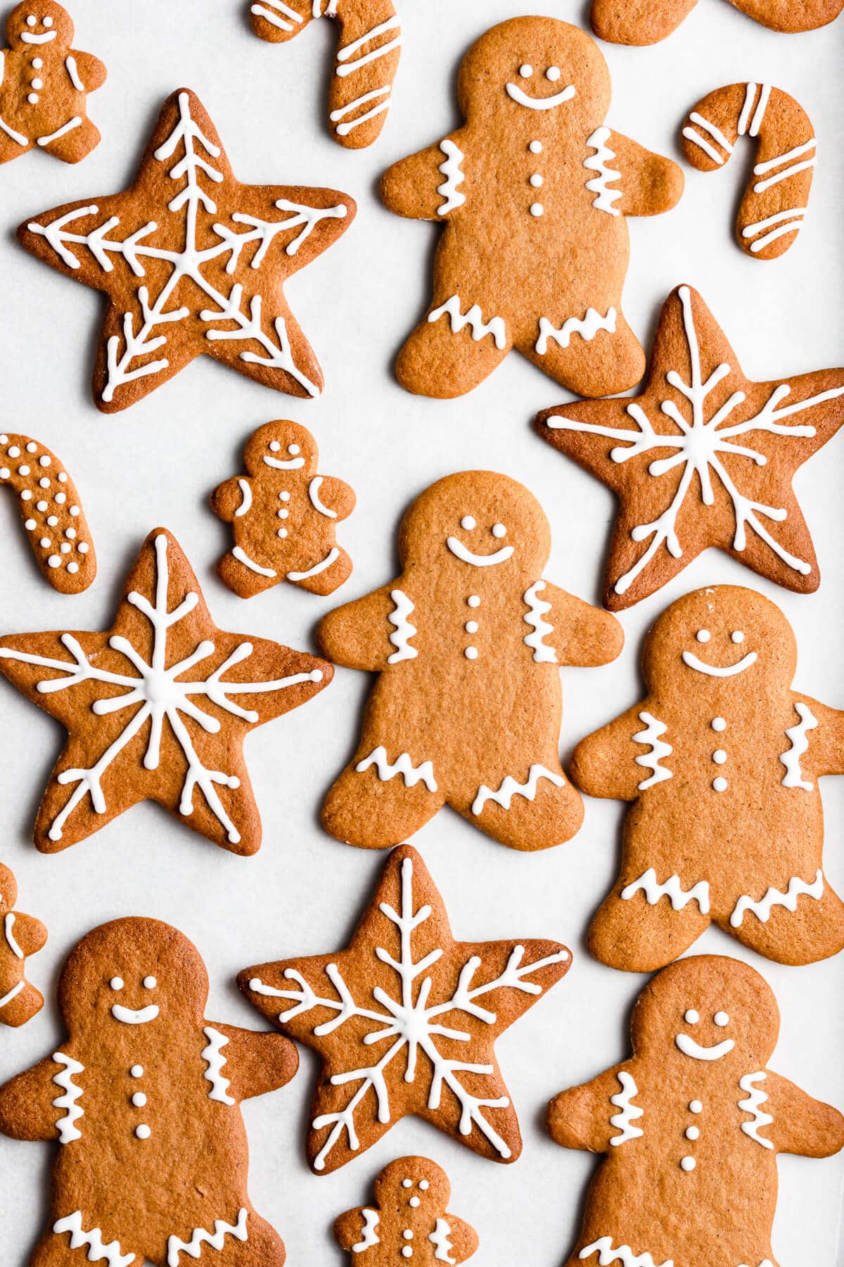 overhead shot of a festive gingerbread cookies on a white surface