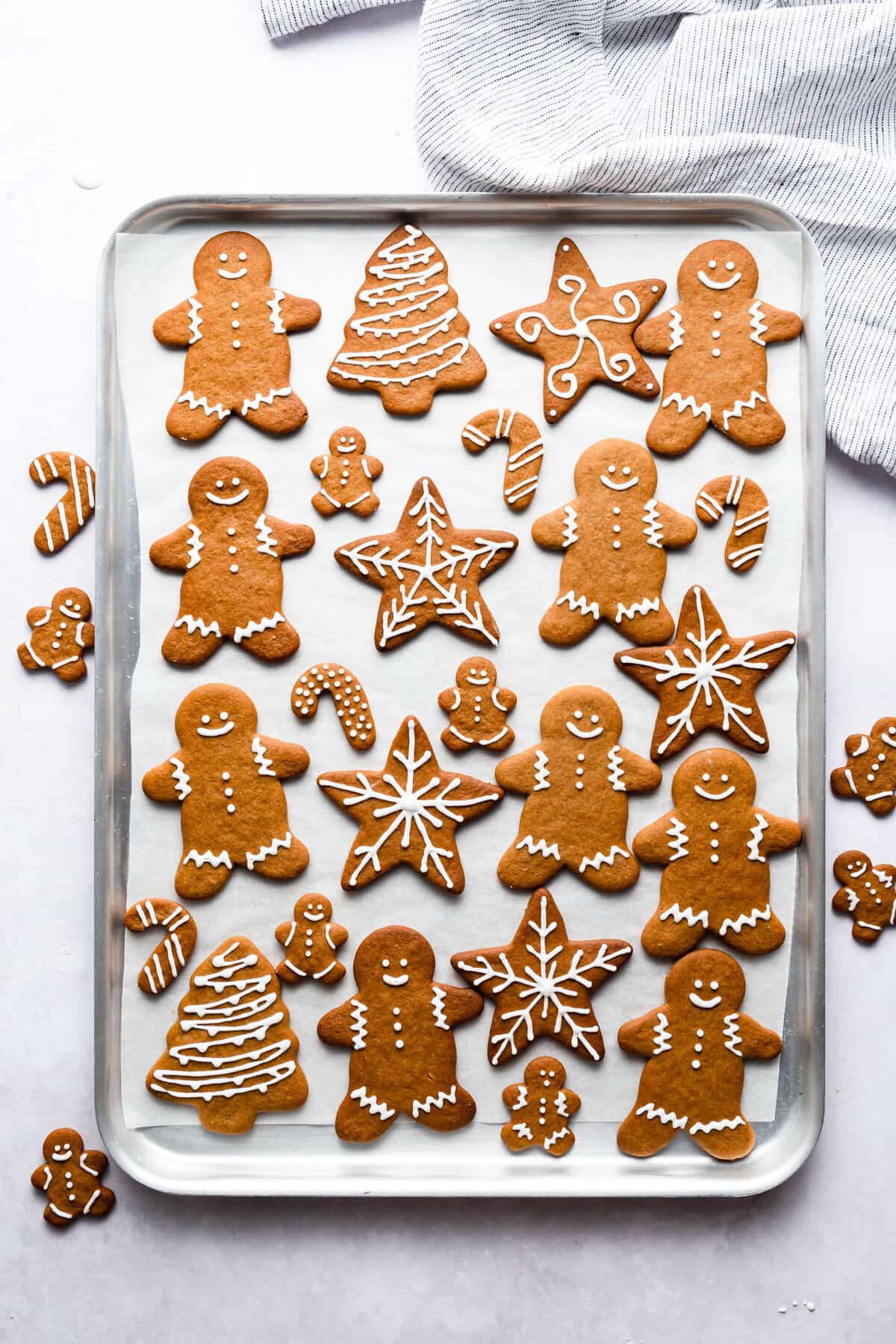top view of a baking sheet filled with baked and decorated soft gingerbread cookies